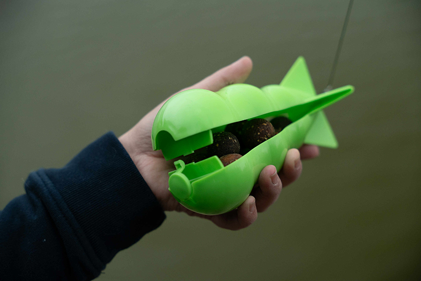 Ribolovac priprema Bomber Rocket raketu za preciznu prihranu u šaranskom ribolovu.